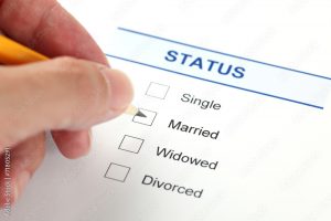 Hand marking marital status checkbox on a form for single status authentication